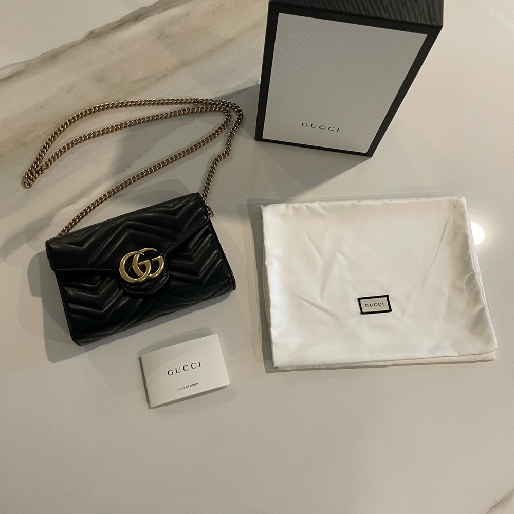 Black Gucci GG Marmont chain mini flap bag with Double G hardware.